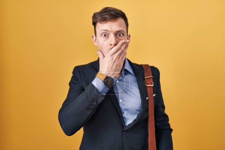 Photo for Caucasian business man over yellow background shocked covering mouth with hands for mistake. secret concept. - Royalty Free Image