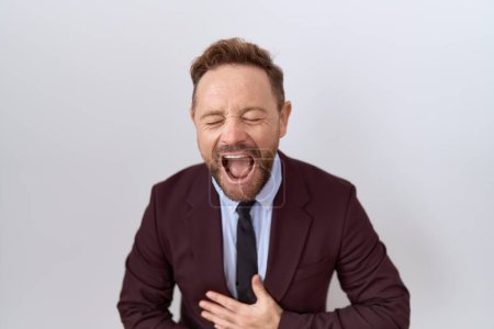 Photo for Middle age business man with beard wearing suit and tie smiling and laughing hard out loud because funny crazy joke with hands on body. - Royalty Free Image