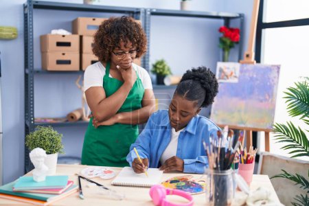 Photo for African american women teacher and student artist drawing on notebook at art studio - Royalty Free Image