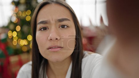 Téléchargez les photos : Jeune belle femme hispanique ayant appel vidéo célébrant Noël à la maison - en image libre de droit