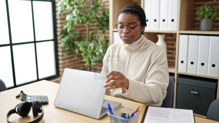 Foto de Mujer afroamericana trabajadora de negocios abriendo laptop trabajando en oficina - Imagen libre de derechos