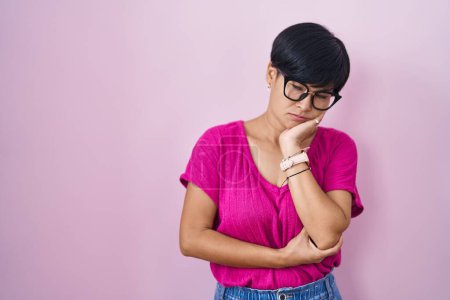 Photo for Young asian woman with short hair standing over pink background thinking looking tired and bored with depression problems with crossed arms. - Royalty Free Image