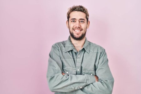Photo for Hispanic man with beard standing over pink background happy face smiling with crossed arms looking at the camera. positive person. - Royalty Free Image