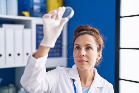 Photo for Young woman scientist looking sample working at laboratory - Royalty Free Image