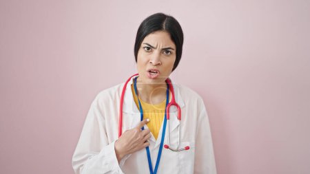 Photo for Young beautiful hispanic woman doctor angry pointing herself over isolated pink background - Royalty Free Image