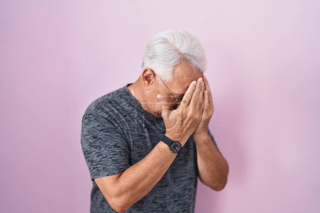 Photo for Middle age man with grey hair standing over pink background with sad expression covering face with hands while crying. depression concept. - Royalty Free Image