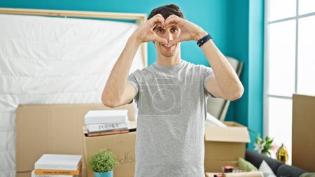 Photo for Young hispanic man doing heart gesture at new home - Royalty Free Image