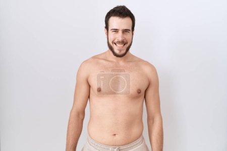 Photo for Young hispanic man standing shirtless over white background with a happy and cool smile on face. lucky person. - Royalty Free Image