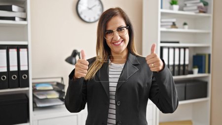 Photo for Middle eastern woman business woman doing ok sign with thumb up at office - Royalty Free Image