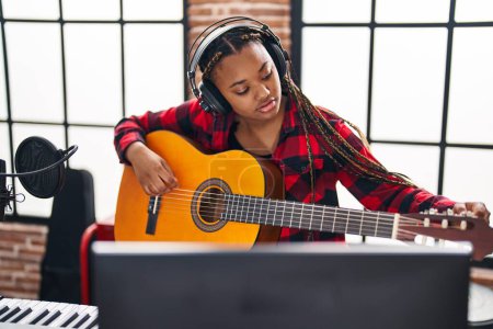 Photo for African american woman musician playing classical guitar at music studio - Royalty Free Image