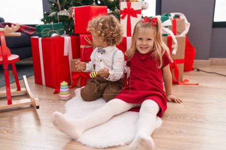 Photo for Adorable boy and girl smiling confident celebrating christmas at home - Royalty Free Image