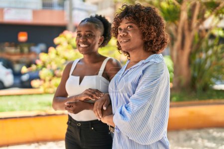 Photo for African american women mother and daughter standing together at park - Royalty Free Image