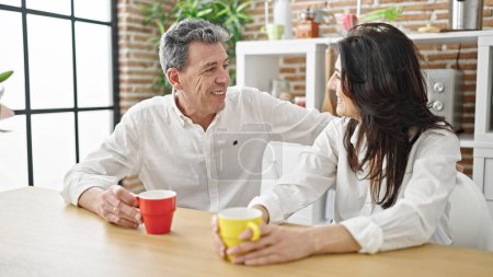 Photo for Senior man and woman couple smiling confident drinking coffee at dinning room - Royalty Free Image