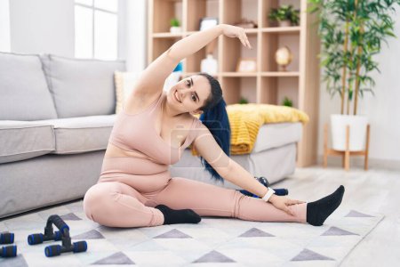 Photo for Young caucasian woman smiling confident stretching at home - Royalty Free Image
