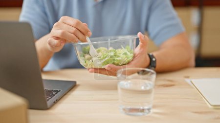 Téléchargez les photos : Homme aux cheveux gris commerce électronique affaires manger de la salade au bureau - en image libre de droit
