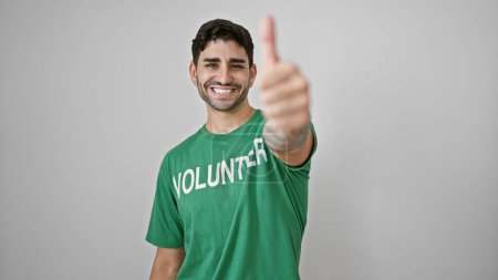 Téléchargez les photos : Jeune homme hispanique volontaire faisant pouce vers le haut souriant sur fond blanc isolé - en image libre de droit