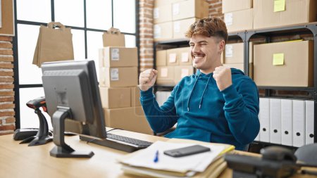Photo for Young hispanic man ecommerce business worker using computer celebrating at office - Royalty Free Image