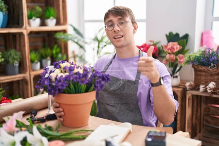 Photo for Caucasian blond man working at florist shop pointing fingers to camera with happy and funny face. good energy and vibes. - Royalty Free Image