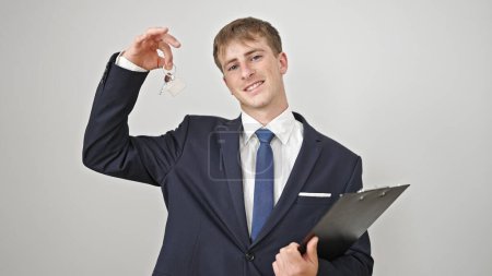 Photo for Young caucasian man real state agent holding keys of new home and contract over isolated white background - Royalty Free Image