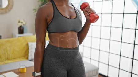 Photo for African american woman using dumbbells training at home - Royalty Free Image
