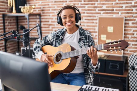 Photo for African american woman musician playing classical guitar at music studio - Royalty Free Image
