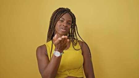 Photo for African american woman smiling confident blowing kiss over isolated yellow background - Royalty Free Image