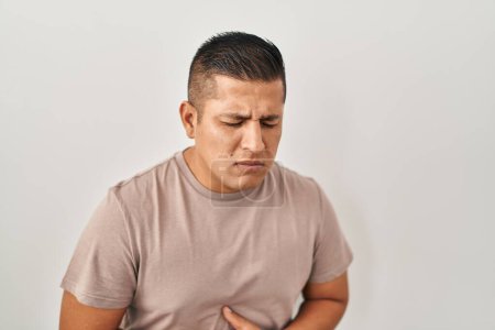Photo for Hispanic young man standing over white background with hand on stomach because nausea, painful disease feeling unwell. ache concept. - Royalty Free Image