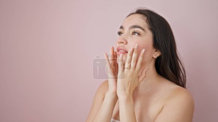 Photo for Young beautiful hispanic woman massaging face over isolated pink background - Royalty Free Image