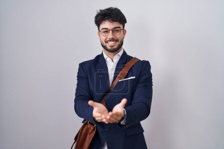 Photo for Hispanic man with beard wearing business clothes smiling with hands palms together receiving or giving gesture. hold and protection - Royalty Free Image
