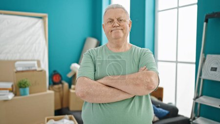 Photo for Middle age grey-haired man smiling confident standing with arms crossed gesture at new home - Royalty Free Image