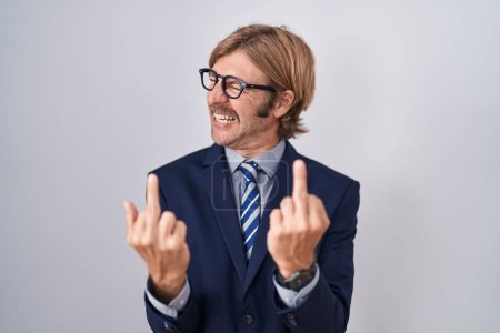 Photo for Caucasian man with mustache wearing business clothes showing middle finger doing fuck you bad expression, provocation and rude attitude. screaming excited - Royalty Free Image