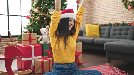 Photo for Young beautiful hispanic woman smiling confident celebrating christmas with winner expression at home - Royalty Free Image