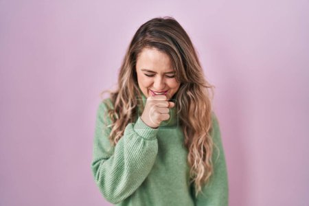 Photo for Young caucasian woman standing over pink background feeling unwell and coughing as symptom for cold or bronchitis. health care concept. - Royalty Free Image