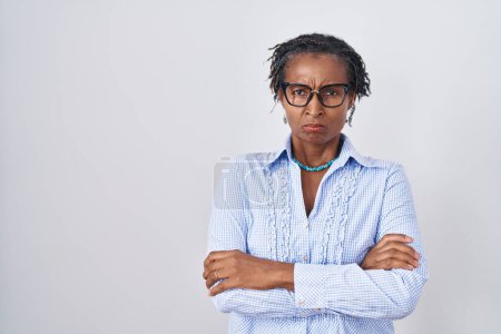 Photo for African woman with dreadlocks standing over white background wearing glasses skeptic and nervous, disapproving expression on face with crossed arms. negative person. - Royalty Free Image