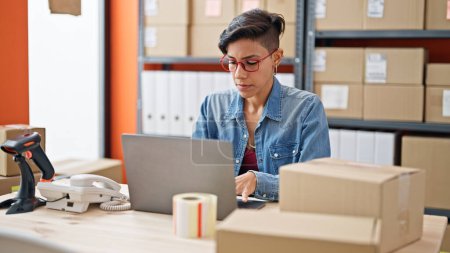 Photo for Young beautiful hispanic woman ecommerce business worker using laptop at office - Royalty Free Image