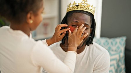 Téléchargez les photos : Afro-américain père et fille portant roi couronne et baggy yeux pad à la maison - en image libre de droit