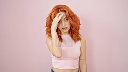 Photo for Young redhead woman stressed standing over isolated pink background - Royalty Free Image
