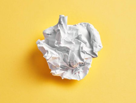 Photo for One white crumpled paper ball over isolated yellow background - Royalty Free Image