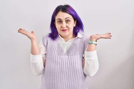 Photo for Plus size woman wit purple hair standing over white background clueless and confused expression with arms and hands raised. doubt concept. - Royalty Free Image