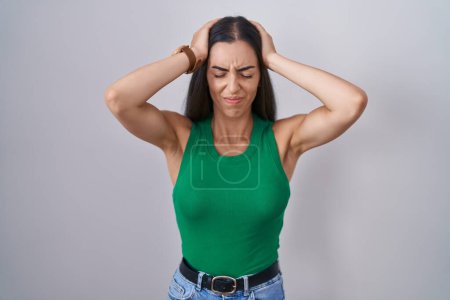 Photo for Young woman standing over isolated background suffering from headache desperate and stressed because pain and migraine. hands on head. - Royalty Free Image