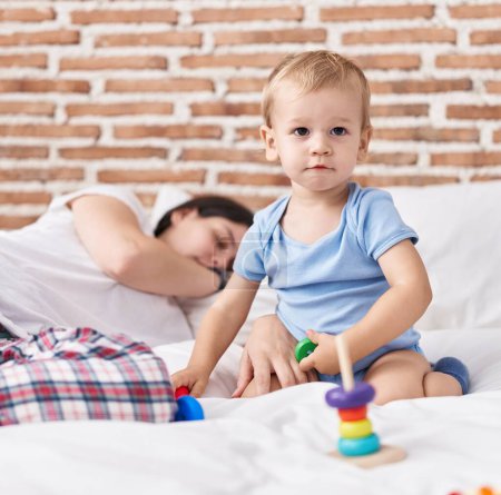 Photo for Mother and son playing on bed and sleeping at bedroom - Royalty Free Image