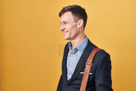 Photo for Caucasian business man over yellow background looking to side, relax profile pose with natural face and confident smile. - Royalty Free Image