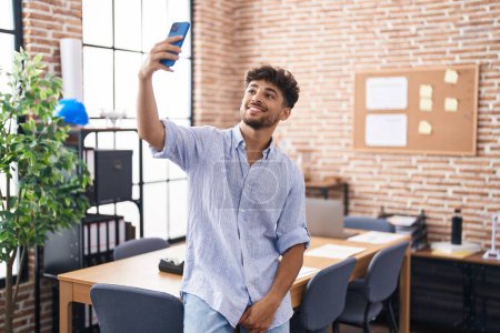 Photo for Young arab man business worker making selfie by smartphone at office - Royalty Free Image