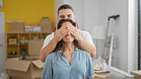 Photo for Man and woman couple surprise covering eyes at new home - Royalty Free Image