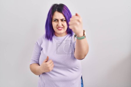 Photo for Plus size woman wit purple hair standing over isolated background angry and mad raising fist frustrated and furious while shouting with anger. rage and aggressive concept. - Royalty Free Image