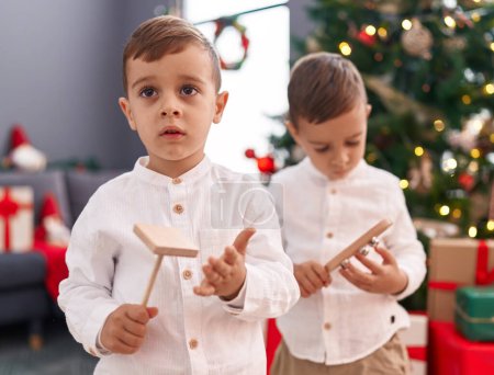 Photo for Adorable boys celebrating christmas at home - Royalty Free Image
