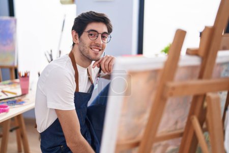 Photo for Young hispanic man artist smiling confident looking draw at art studio - Royalty Free Image