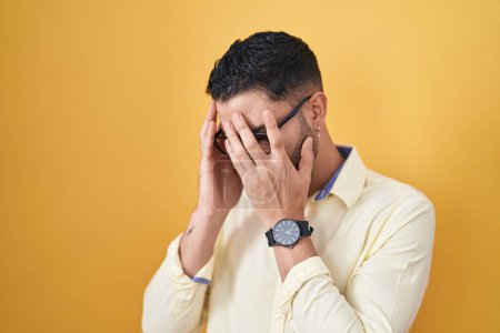 Photo for Hispanic young man wearing business clothes and glasses with sad expression covering face with hands while crying. depression concept. - Royalty Free Image