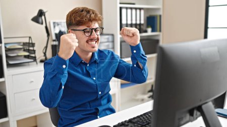 Photo for Young hispanic man business worker using computer celebrating at the office - Royalty Free Image