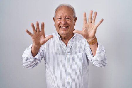 Photo for Senior man with grey hair standing over isolated background showing and pointing up with fingers number ten while smiling confident and happy. - Royalty Free Image